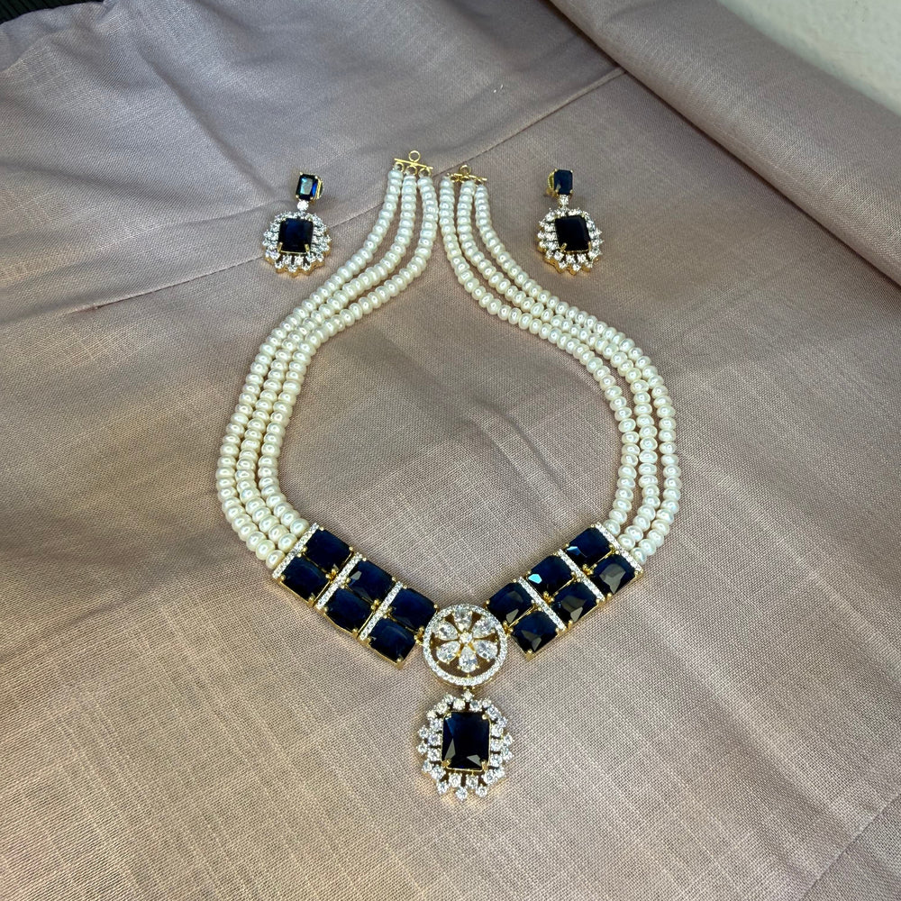 Jewelry set with necklace and earrings on a textured surface